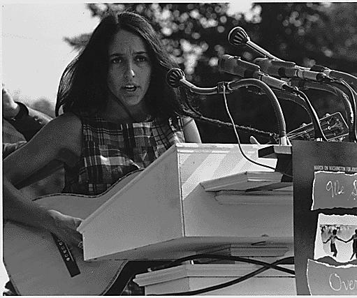 Civil Rights March on Washington, D.C. [Entertainment: Vocalist Joan Baez. A sign hanging near the microphones reads "We Shall Overcome." ], 08/28/1963 photo by flickr http://www.flickr.com/photos/usnationalarchives/6053190883/in/set-72157627456510830/